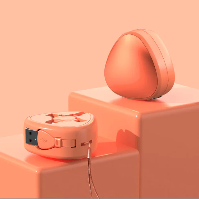 Two peach-colored electronic devices on a peach background