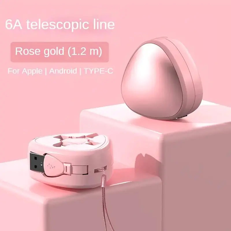 Rose gold telescopic charging cable on a pink background