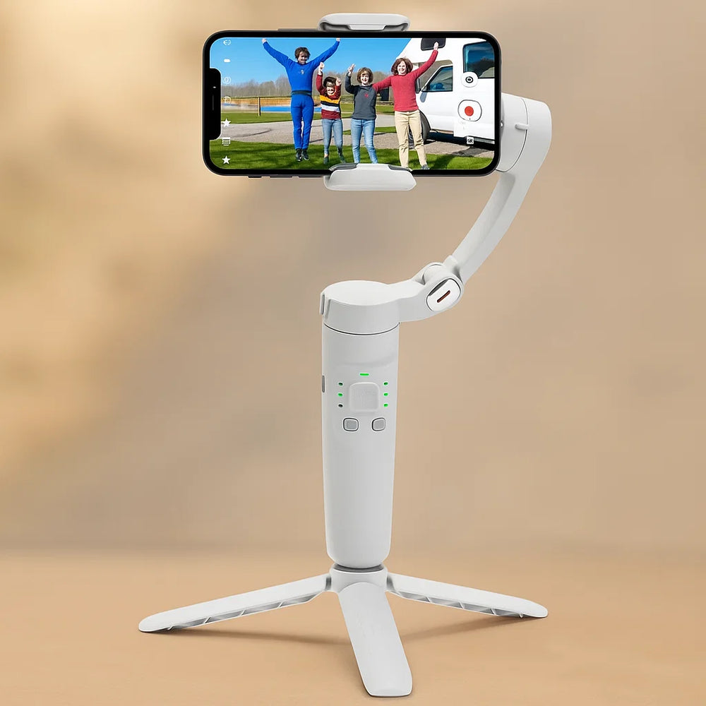 White smartphone gimbal with a phone displaying a video of four people in front of a van on a beige background.